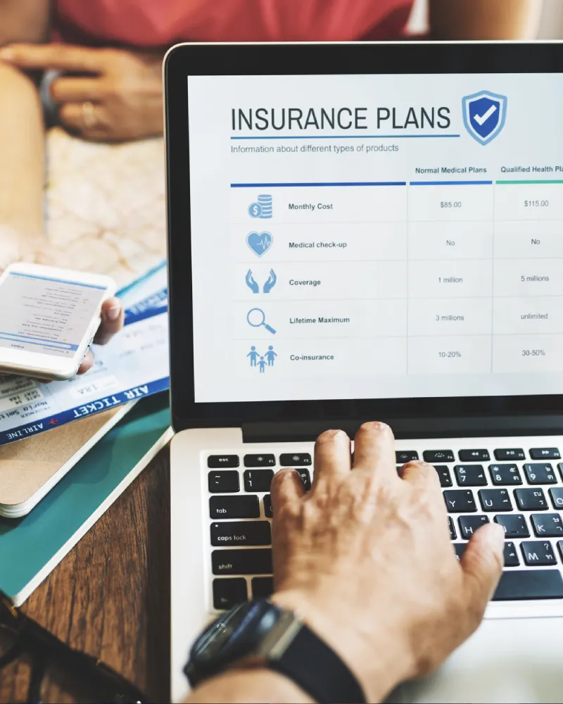 Person comparing health insurance options on a laptop